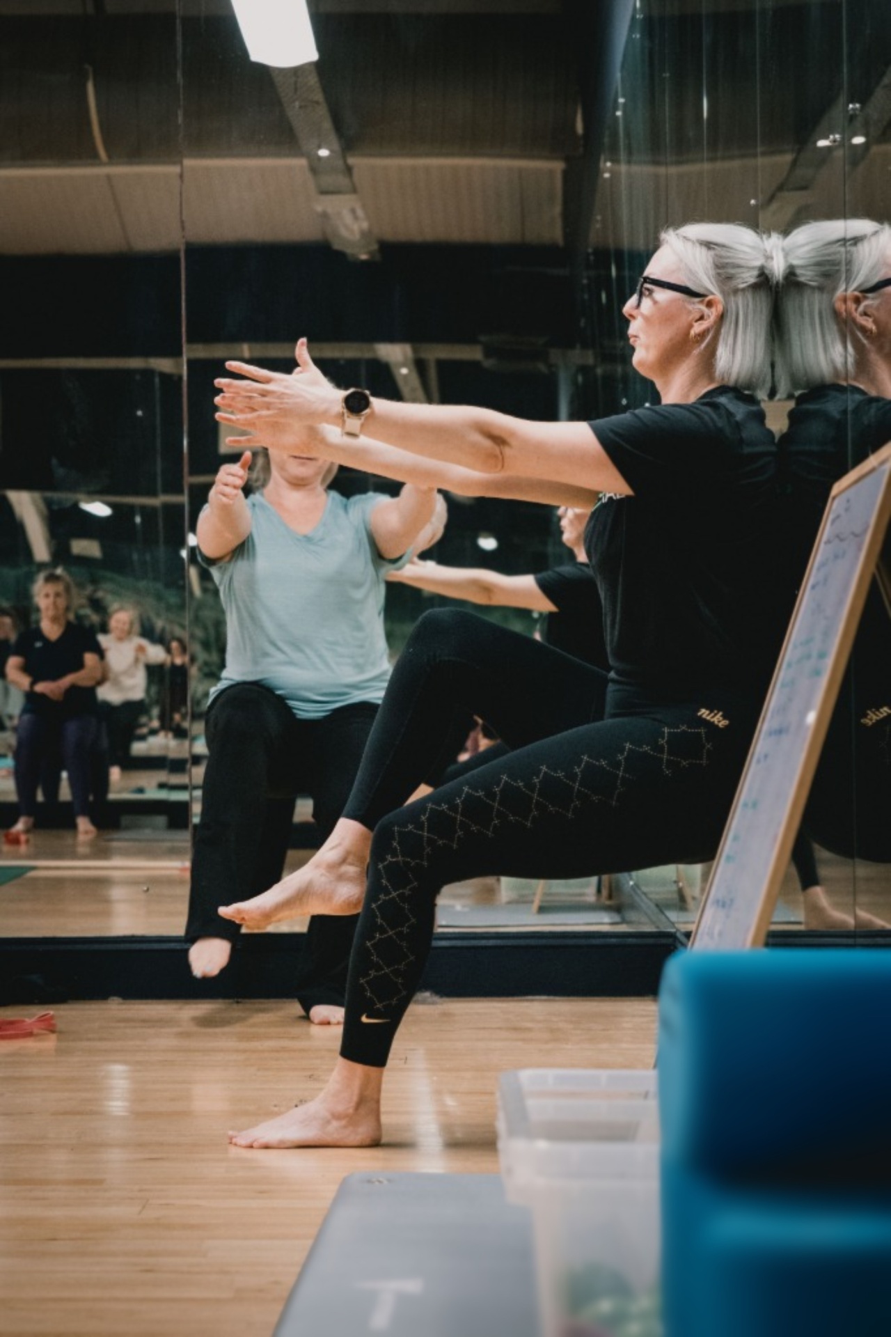 Client performing single-leg balance and control work during a class