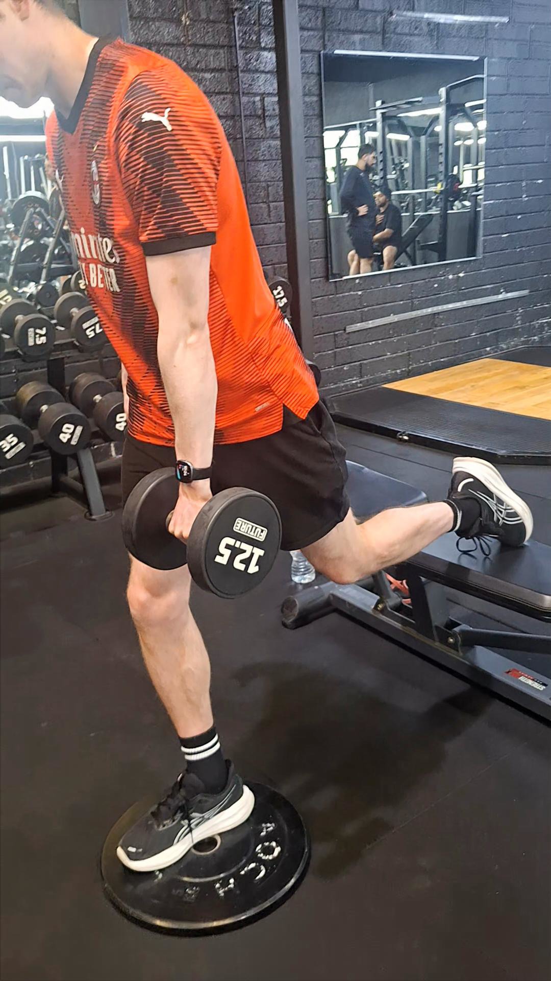 Athlete performing a weighted Bulgarian split squat