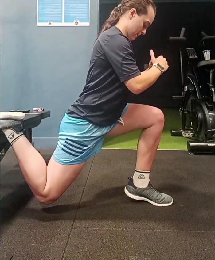 Athlete performing a supported split lunge