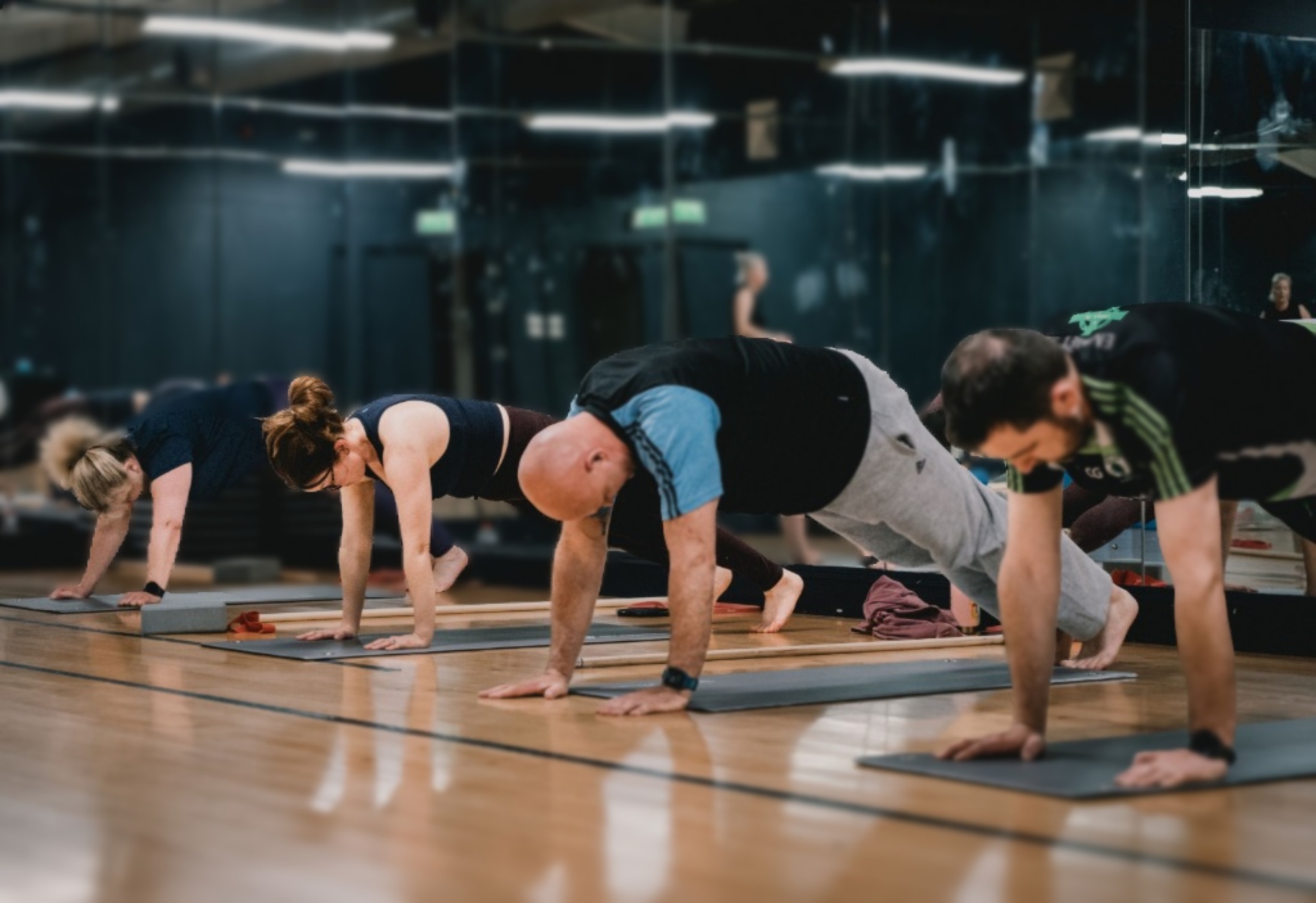 Group class holding plank positions on mats