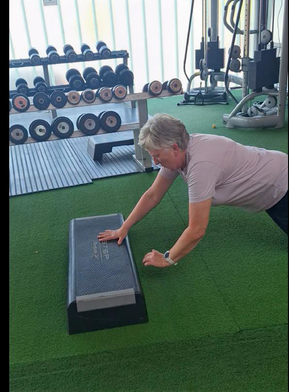 Client performing an elevated plank using a step