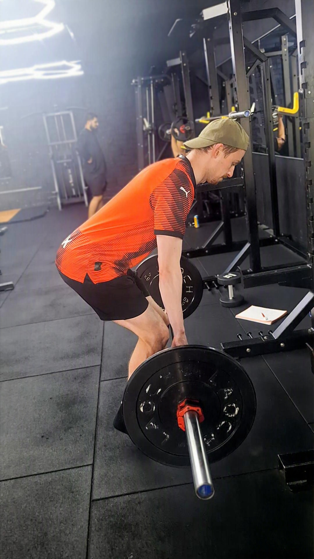 Athlete performing a barbell deadlift in the gym