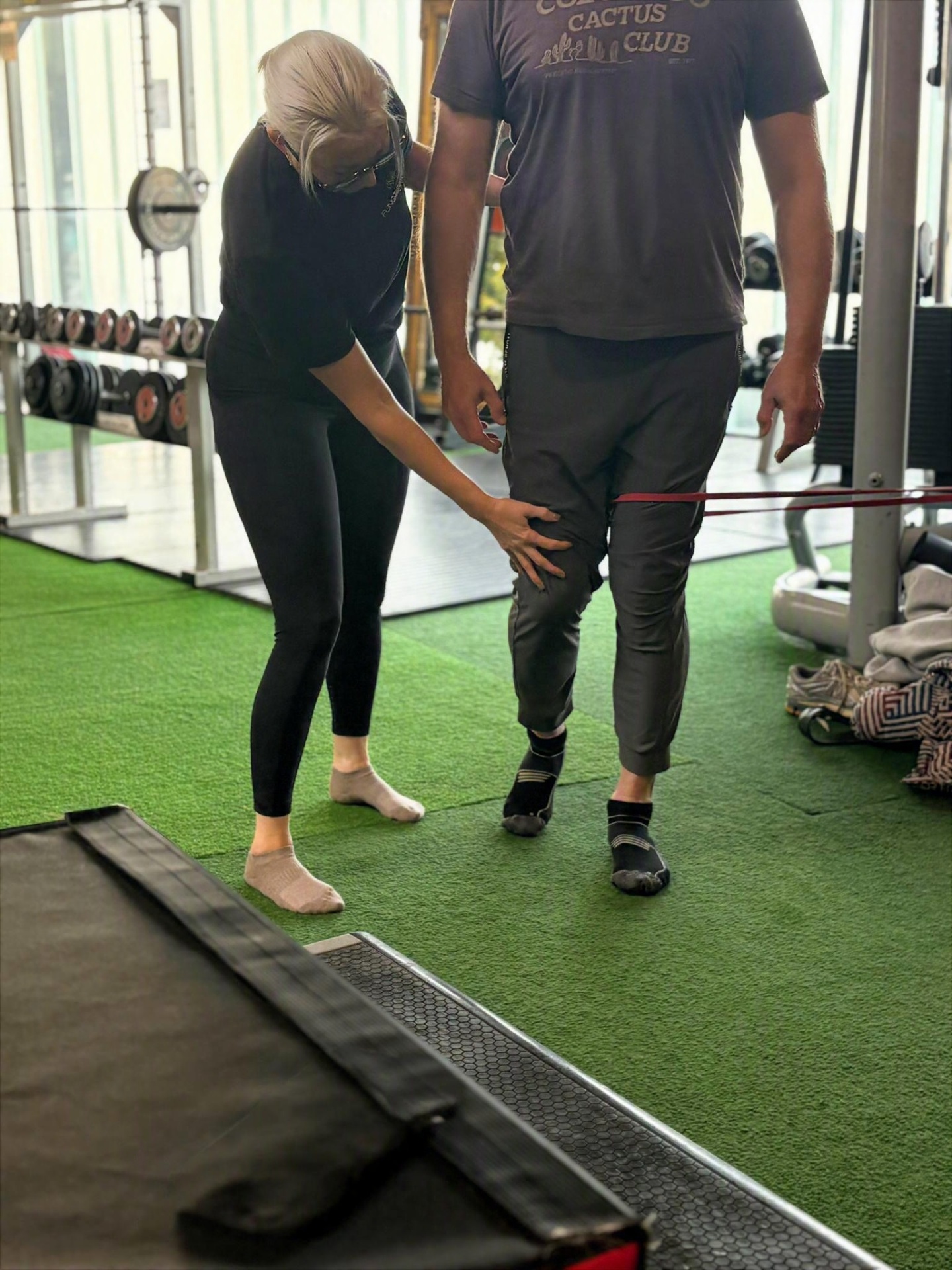 Riona guiding knee control during a banded exercise