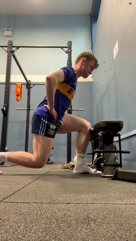 Athlete performing a half-kneeling hip mobility exercise